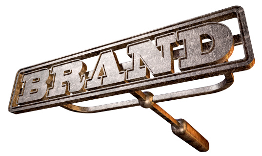 A metal cattle brand with the word brand as the marking area on an isolated background