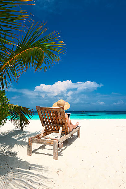 istock Young woman with tablet pc at the beach 464536282
