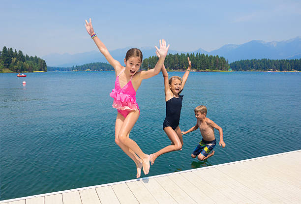 istock Kids playing at the lake on their summer vacation 464537734