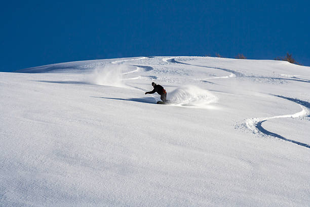 istock Snowboarder go down on powder snow. 464538947