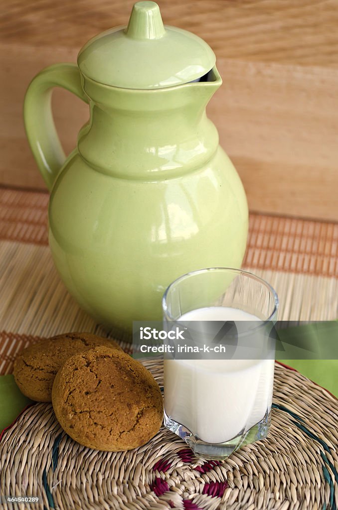 cookies and milk Oat cookies and milk on a round wattled support. Backgrounds Stock Photo