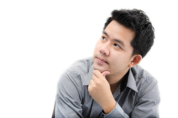 istock Portrait of young man looking up on white background 464542216