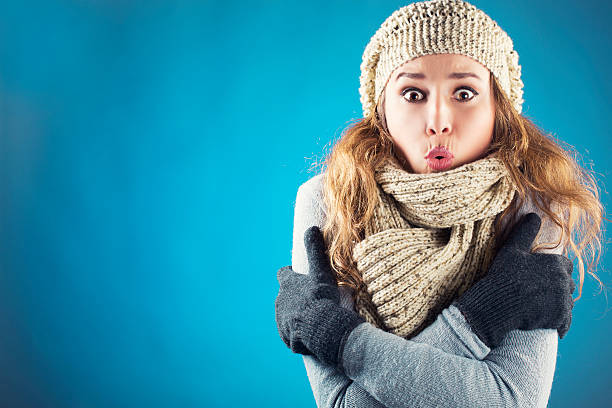 Freezing Young woman with scarf beret and glove shivering cold temperature stock pictures, royalty-free photos & images
