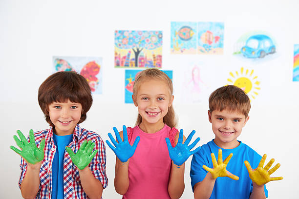 istock Happy children showing painted hands 464542836