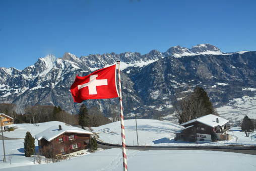 Swiss Mountain in the alps with snow and Switzerland flagg 