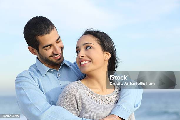 Arab Casual Couple Cuddling Happy With Love On The Beach Stock Photo - Download Image Now