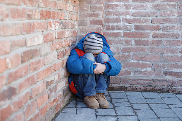 istock homeless boy leaned against the wall 464543474