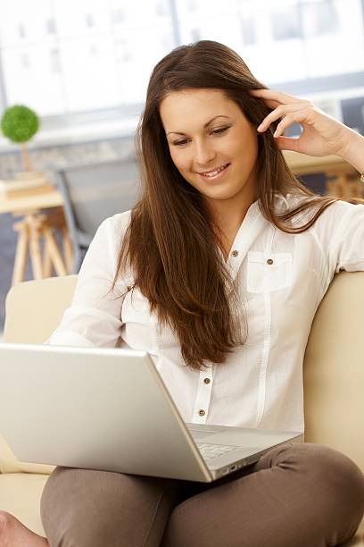 istock Young woman with laptop 464544421