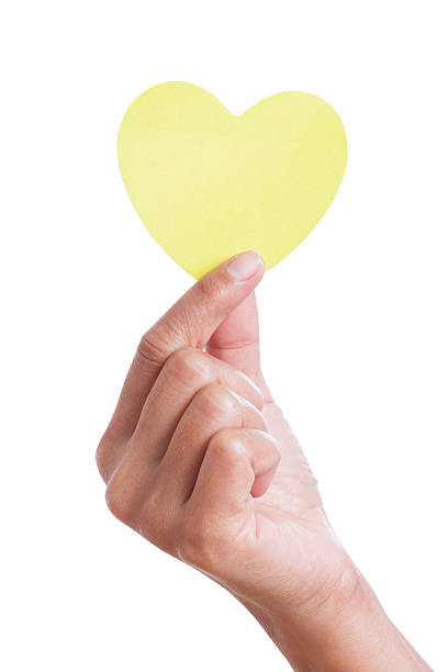 istock Female hand holding paper heart 464548665