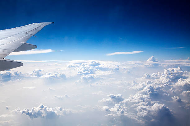 istock Clouds and sky as seen through window of an aircraft 464553156