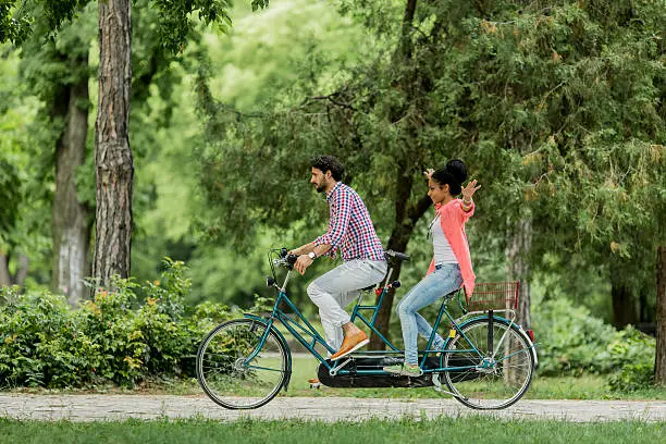 Young couple riding on the bicycle