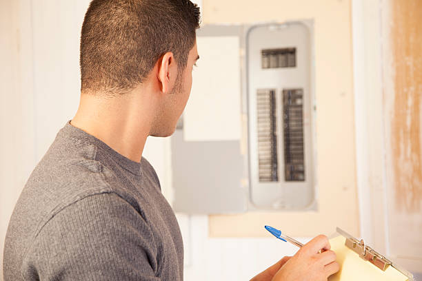 istock Service Industry: Electrician writes repair estimate for home owner. 464556469