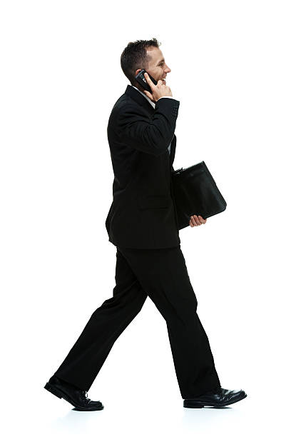 istock Smiling businessman talking on mobile and walking 464556559
