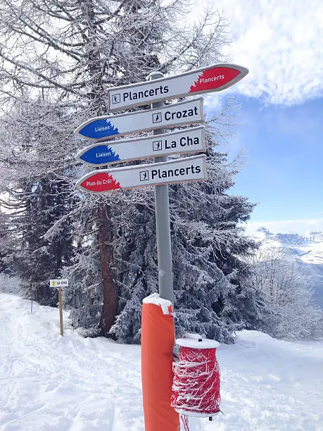 Signpost giving directions to different ski slopes at alpine skiing areas in French Alps, Chamonix, les Houches