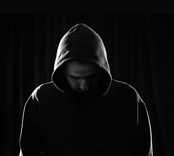 istock Unrecognizable man with hoodie in the dark 464556777