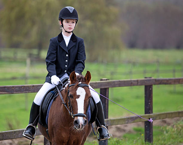 girl riding a horse during competition