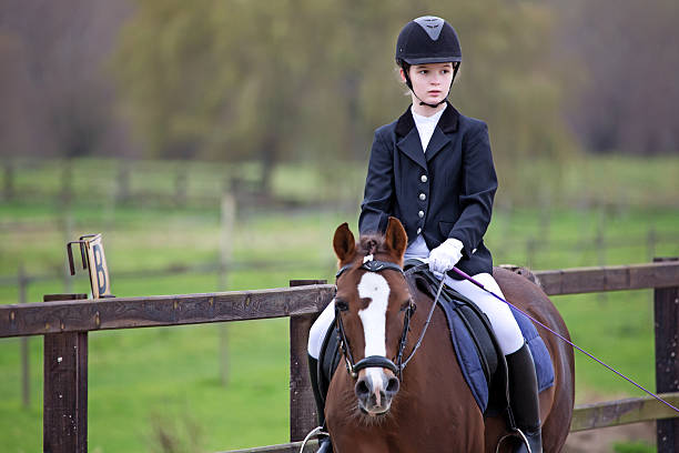 istock girl riding a horse during competition 464559803