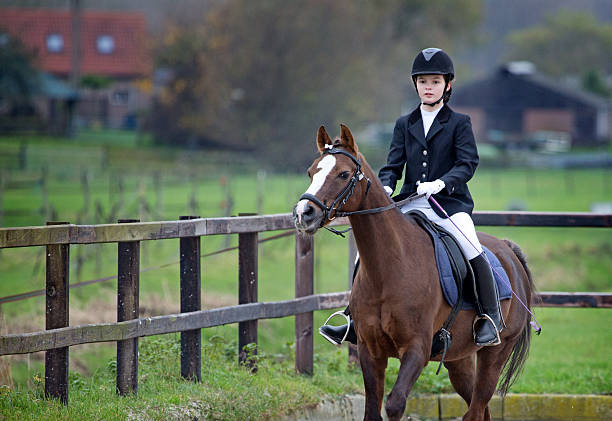 istock girl riding a horse during competition 464559851