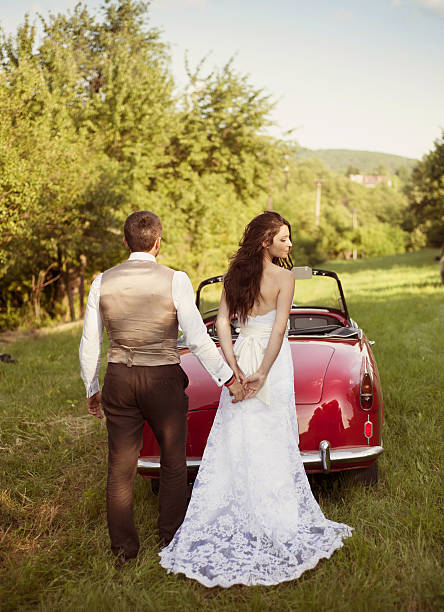 istock Wedding car with bride and groom 464561107