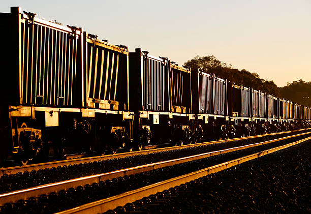 istock Empty ore cars glint at sunset 464561447