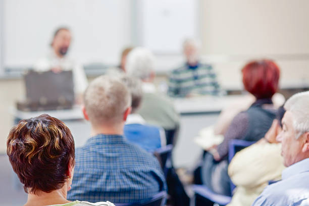 istock Group of people facing each other at a table 464561915