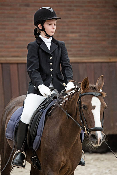 istock riding a horse girl 464565595