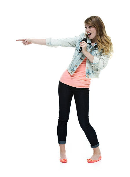 Smiling woman pointing with microphone Smiling woman pointing with microphonehttp://www.twodozendesign.info/i/1.png 15 year old blonde girl stock pictures, royalty-free photos & images