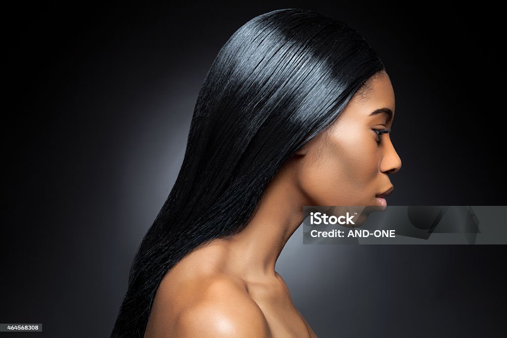 Profile of an young black beauty with long straight hair Profile of an young black beauty with long straight and shiny hair Straight Hair Stock Photo