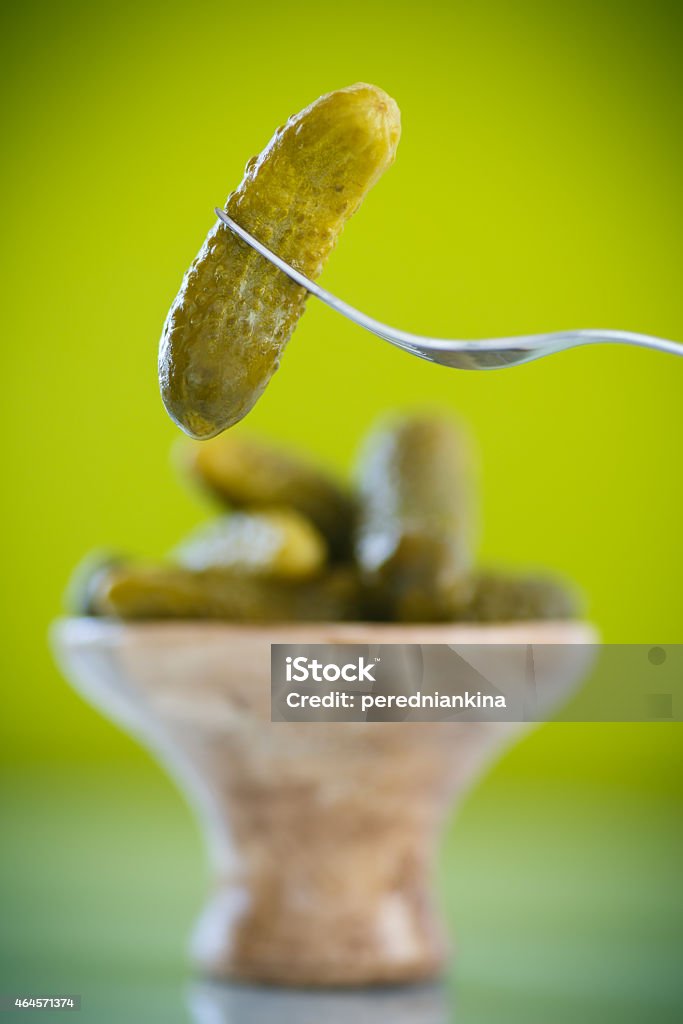 pickled cucumber pickled cucumber with a fork on green background 2015 Stock Photo