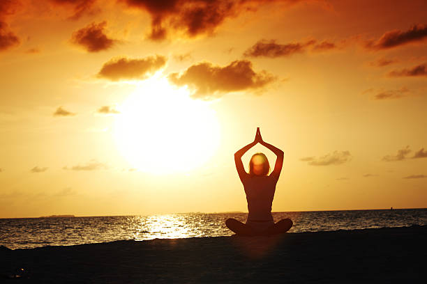 istock sunset yoga woman 464572497