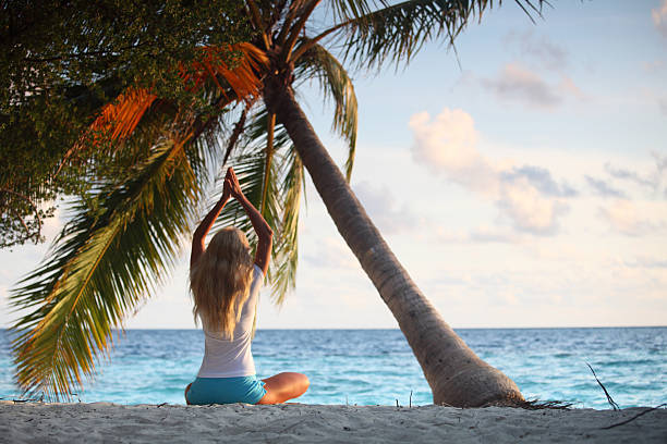 istock yoga woman under palm 464572505