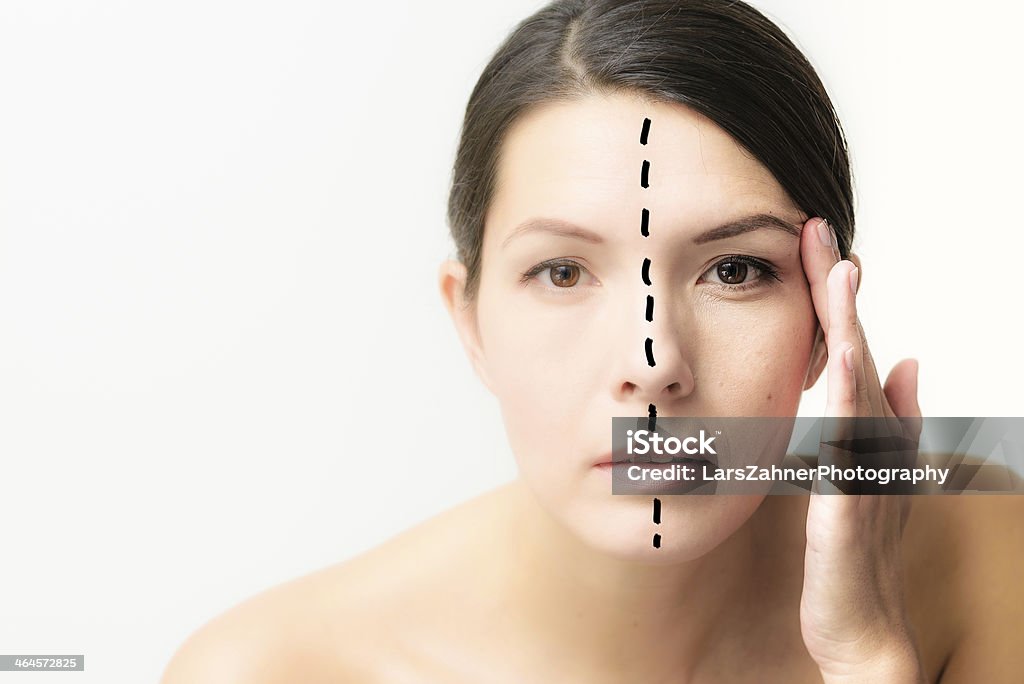 Woman with her face divided to show aging Woman with her face divided down the centre to show the effect of aging with one half beautiful and youthful and the other showing cell catabiosis with the appearance of wrinkles Adult Stock Photo