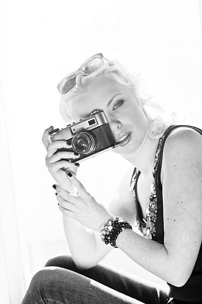 istock woman photographer with camera 464573371
