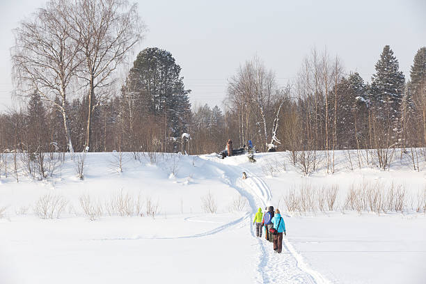 istock People walk along trail up the mountain in winter 464577554