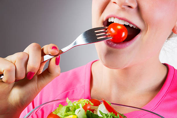 istock Unrecognizable woman eating salad 464577662