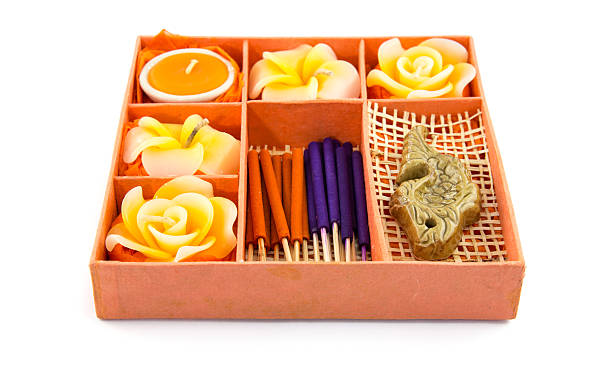 Spa Set. Roses Shaped Candles, incense sticks in orange box on white background
