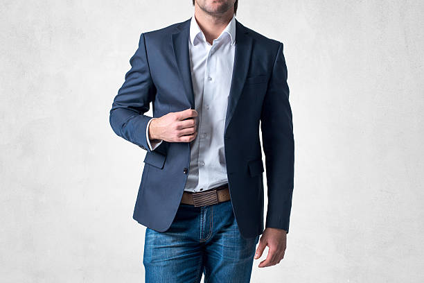 istock Man in trendy suit  standing alone holding his jacket with 464577962