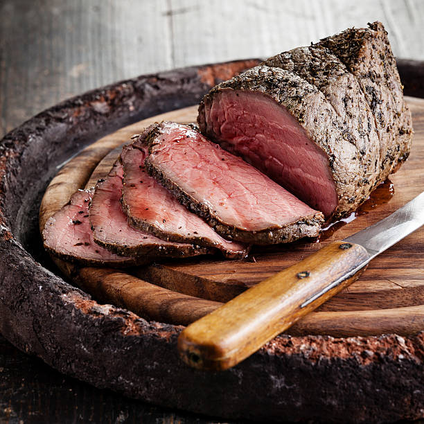 Roast beef Roast beef on cutting board and knife roast beef photos stock pictures, royalty-free photos & images