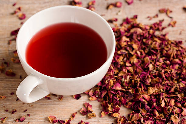 istock cup of rose tea with rose tea leafs 464583446