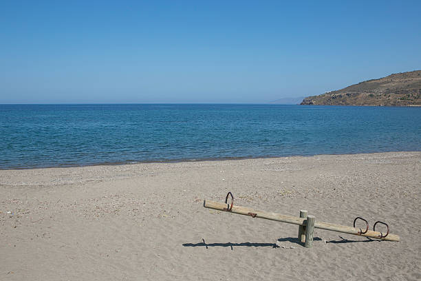empty coast of petra town  beach with teeterboard in lesbos island at greece