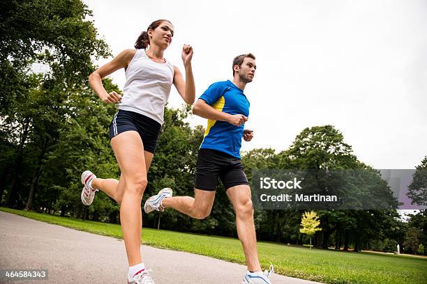 Jogging Together Sport Young Couple Stock Photo - Download Image Now - Running, Couple - Relationship, Men