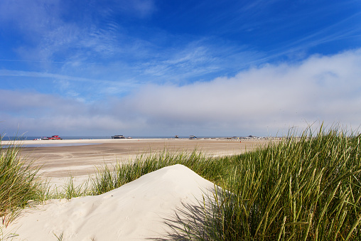 Sand dune in Helgoland under blue sky with clouds, Schleswig-Holstein, Germany