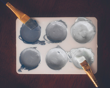 Paint palette with paint colors in various shades of gray