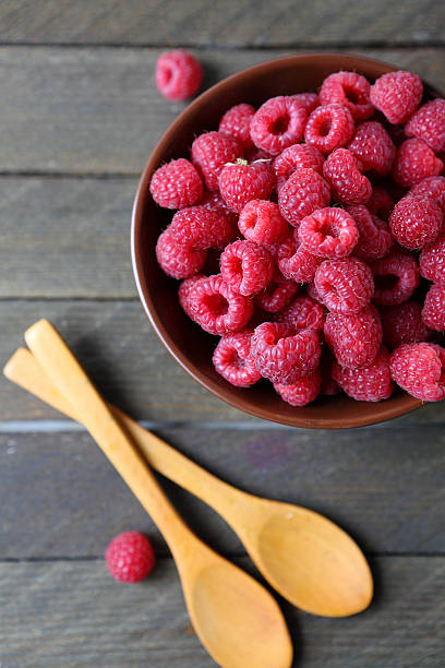 istock raspberries and wooden spoons 464586513
