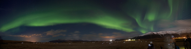 Dramatic panoramic photo of the Northern Lights in Iceland, taken just outside ReykjavÃ­k.  This is a composite of 4 photographs.