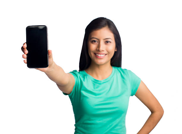istock Confident woman showing mobile phone 464590052