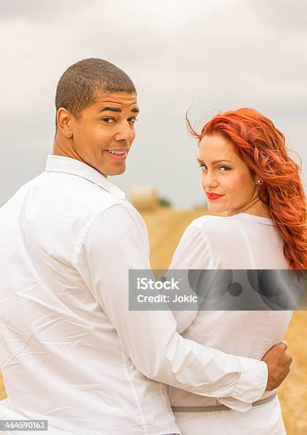 Couple In The Field Stock Photo - Download Image Now - 2015, Adult, Adults Only