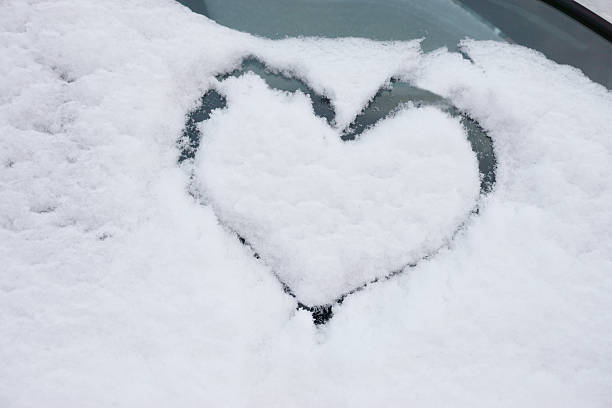 istock heart in the snow on the car window 464590230