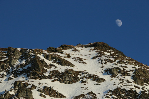 moon, daytime photo, on a mountain ridge, moonrise, moon in winter