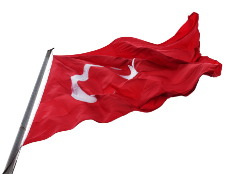 Waving flag of Turkey with flagpole. Isolated on white background.